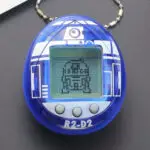 R2-D2 Tamagotchi with digital pet care and Star Wars mini-games.