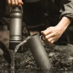 GRAYL UltraPress Ti Covert is a titanium water bottle featuring OnePress purification and cooking capabilities, ensuring clean water and efficient cooking in one sleek design.